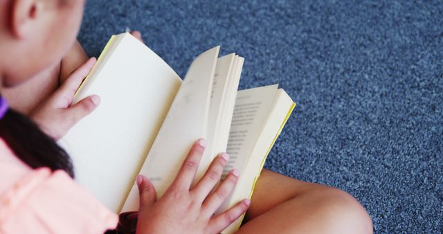 Schoolgirl Absorbed in Reading on Carpeted Floor - Download Free Stock Images Pikwizard.com