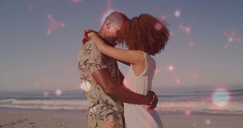Romantic Couple Embracing by the Ocean with Dreamy Lens Flares