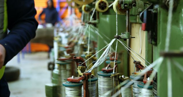 Industrial Machinery with Worker Handling Spools in Factory - Download Free Stock Images Pikwizard.com