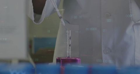 Scientist Performing Test with Pipette in Laboratory
