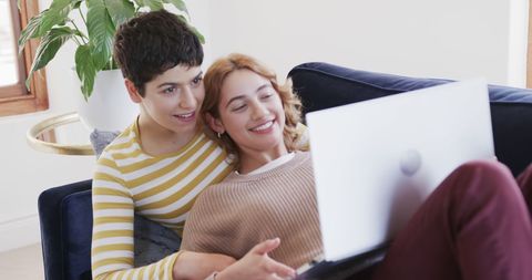 Happy Lesbian Couple Relaxing on Sofa with Laptop - Download Free Stock Images Pikwizard.com