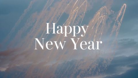 Happy New Year Text Over Dusk Sky with Golden Firework Trails and Soft Smoke