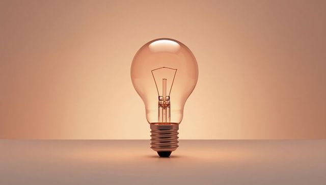 Classic edison bulb glowing against warm organic tone