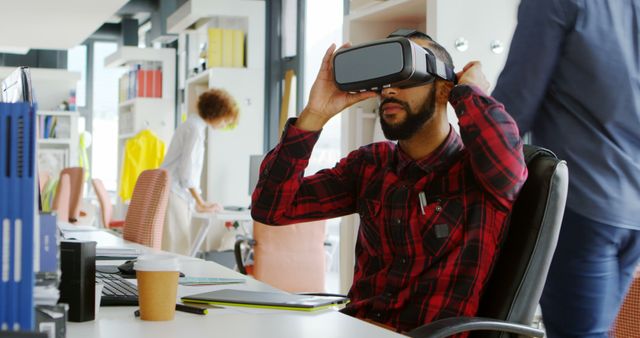 Man Wearing VR Headset at Modern Office Workspace - Download Free Stock Images Pikwizard.com