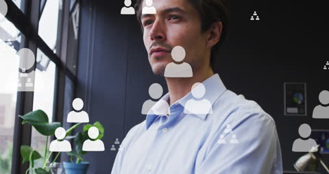 Thoughtful Professional surrounded by Digital Profile Icons in Office