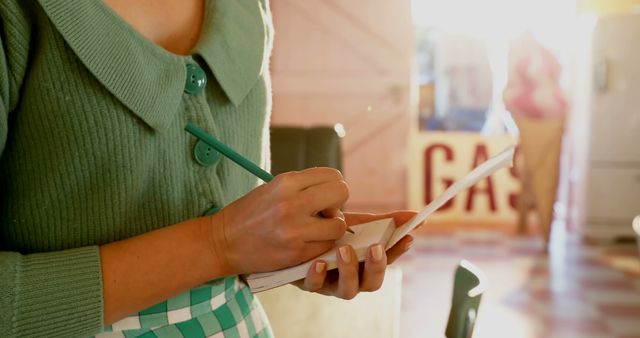 Close-up of retro waitress writing an order in a diner - Download Free Stock Images Pikwizard.com