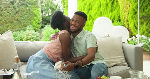 Happy Couple Embracing During Celebration on Patio