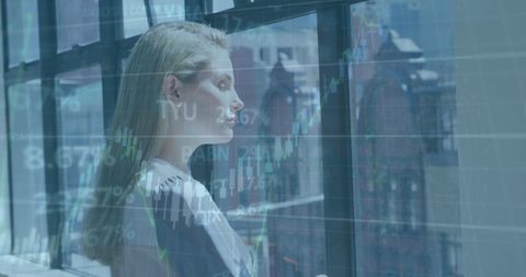 Businesswoman Observing Financial Data in Modern Office - Download Free Stock Images Pikwizard.com