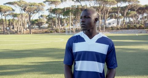 Confident soccer player on artificial turf field