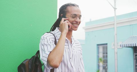 Biracial Young Professional Conversing on Smartphone Outdoors