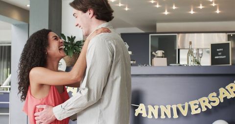 Joyful couple celebrating anniversary in modern home