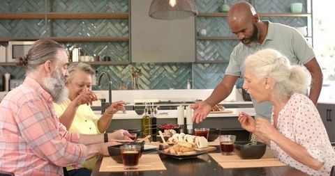 Senior Friends Enjoying Celebratory Meal at Dining Table