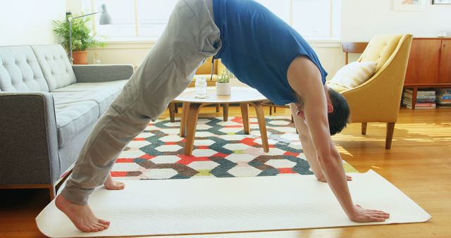 Young Man Practicing Downward Dog Pose in Living Room - Download Free Stock Images Pikwizard.com