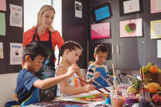 Teacher assisting young students in an art class. Children are painting and drawing, engaging in creative activities. Ideal for educational content, school brochures, art class promotions, and articles on childhood development and creativity.