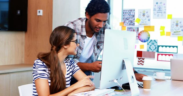 Young colleagues collaborating on computer in modern office - Download Free Stock Images Pikwizard.com