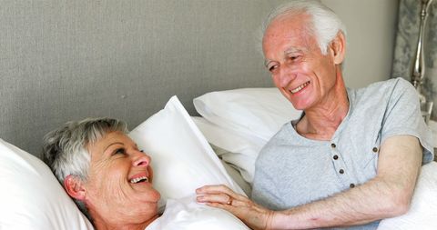 Happy Senior Couple Relaxing and Smiling Together in Bedroom - Download Free Stock Images Pikwizard.com