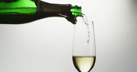 Pouring Champagne into Glass for New Year's Celebration