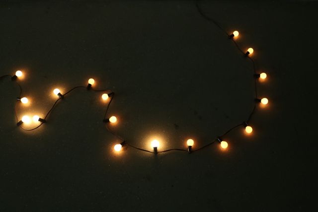 Warm String Lights Forming Curvy Line on Dark Background - Download Free Stock Photos Pikwizard.com