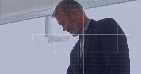 Business Executive Analyzing Data with Digital Overlay Grid
