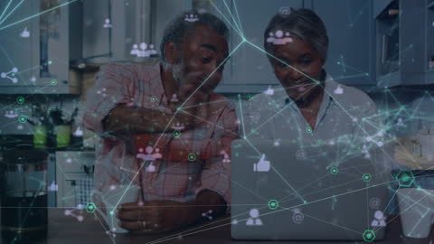 Senior Couple Connecting Digitally with Laptop at Home