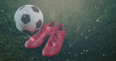 Modern soccer theme with red cleats and football on turf
