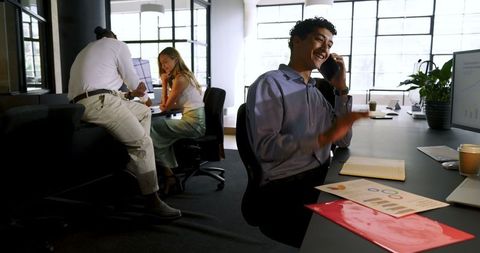 Young Professional Communicating on Phone in Modern Office