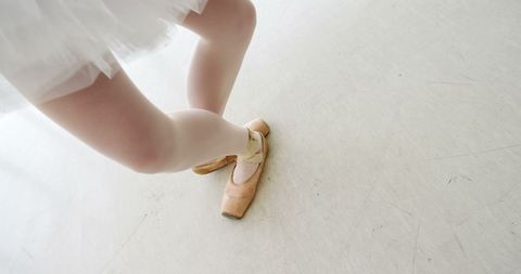 Close-Up of Ballerina Feet in Pointe Shoes on Dance Floor - Download Free Stock Images Pikwizard.com