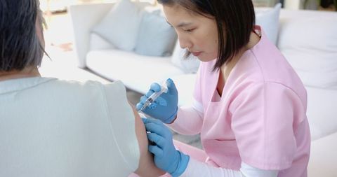 Healthcare Worker Administering Vaccine to Elderly Patient