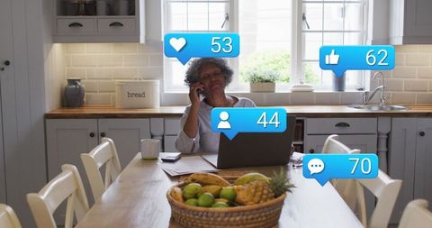 Senior Woman Engaged with Technology at Home Kitchen