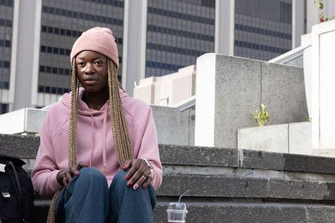 African american woman sitting on urban steps