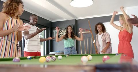 Diverse Group of Friends Enjoying Billiards Game Together