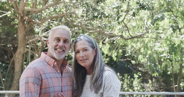 Happy Mature Couple Embracing Outdoors Amid Lush Greenery - Download Free Stock Images Pikwizard.com