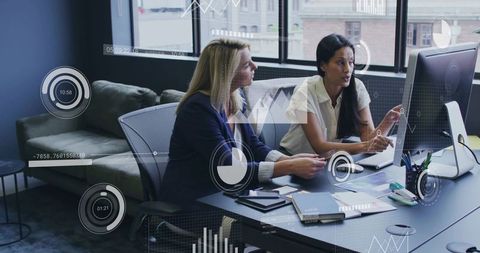 Businesswomen Discussing Data Analysis in Modern Office
