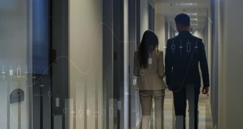 Business Professionals Analyzing Financial Data in Office Corridor