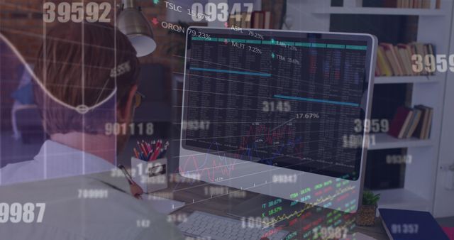 Businessman studies detailed stock market data displayed on computer monitor in modern office. Ideal for use in stories about finance, trading, economic research, and investment strategies.