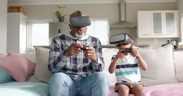 Grandfather and grandson sharing a fun moment while using VR headsets and gaming controllers. Perfect for illustrating family bonding, intergenerational activities, technology in everyday life, and the joy of sharing modern experiences with different generations.