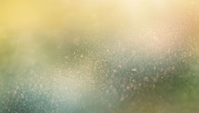 Ethereal drifting dust bokeh over warm teal gradient, dreamy abstract texture