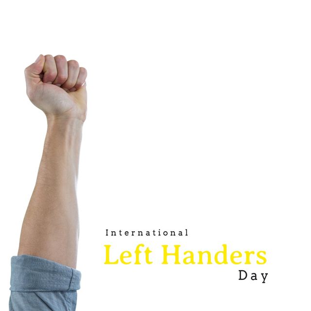 Image shows a caucasian man's fist raised up, symbolizing celebration and solidarity, with text 'International Left Handers Day' clear on the right. White background with ample copy space makes it useful for promotional materials, social media posts, and awareness campaigns related to left-handed inclusivity and events.