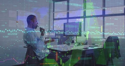 Businessman analyzing data on computer with digital interface overlay