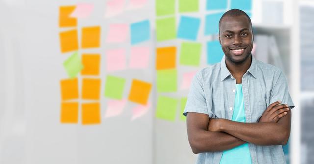 Confident Executive Standing with Arms Crossed in Office with Colorful Sticky Notes - Download Free Stock Images Pikwizard.com