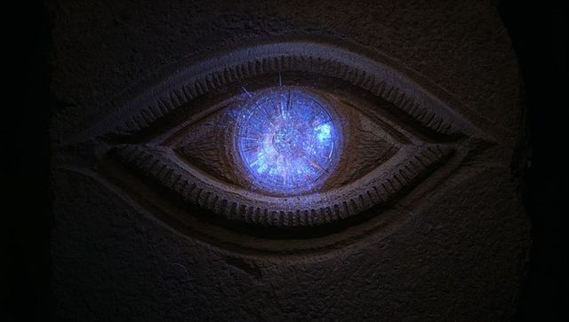 Mystical Glowing Stone Eye Relief in Ancient Chamber