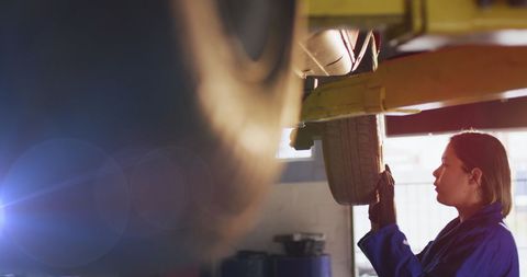 Female Mechanic Examining Tires in Auto Repair Shop - Download Free Stock Images Pikwizard.com
