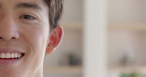 Half face portrait of smiling man in cozy interior setting