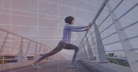 technology in fitness: woman in hijab stretching on bridge with data overlay - Download Free Stock Images Pikwizard.com