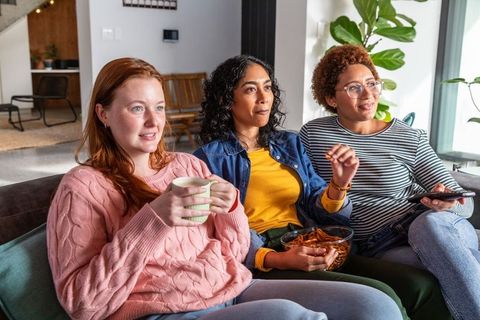 Diverse Female Friends Relaxing Together on Cozy Couch