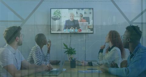Diverse Team Conducts Video Conference in Modern Office Setting
