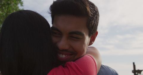 Happy Couple Embracing Outdoors with Sunny Sky