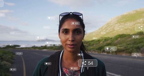 Confident woman traveling coastline with social media cloud