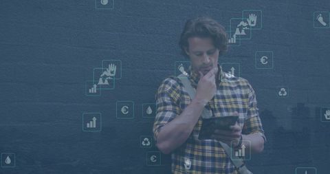 Contemplative Man Analyzing Data on Tablet with Environmental Icons