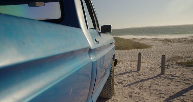 Blue car parked on sunny beach with copy space - Download Free Stock Photos Pikwizard.com